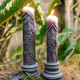 Pillar candles with a Elvish sword design set against a jungle